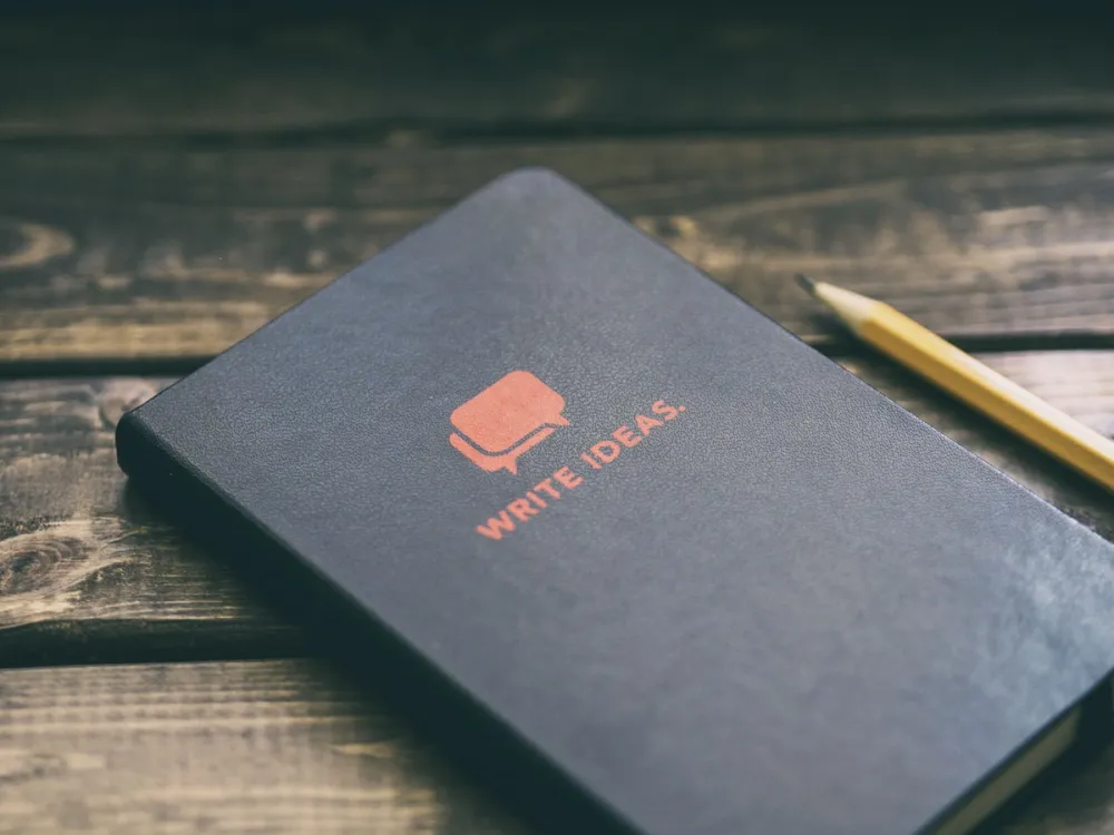 Marked-up pages and red pen on a desk